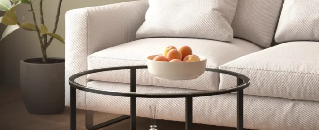 Een glazen tafel met een schaal fruit erop
